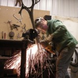 Sam Spiczka grinding one of his sculptures at his studio.